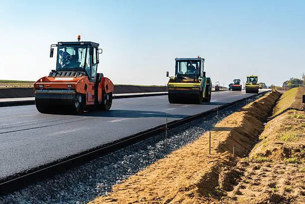 Road compaction machinery on pavement work